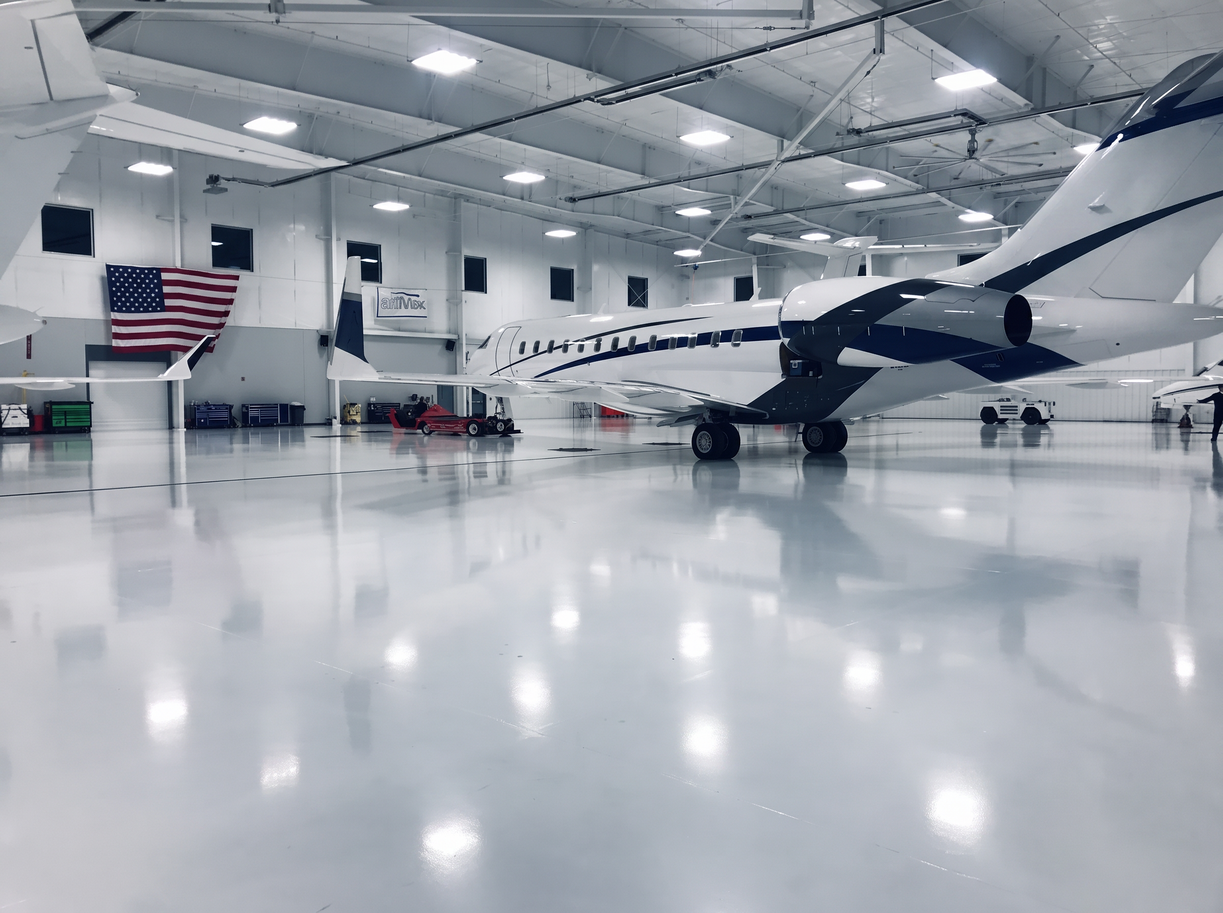 Large-cabin business jets inside the bright Airmax hangar