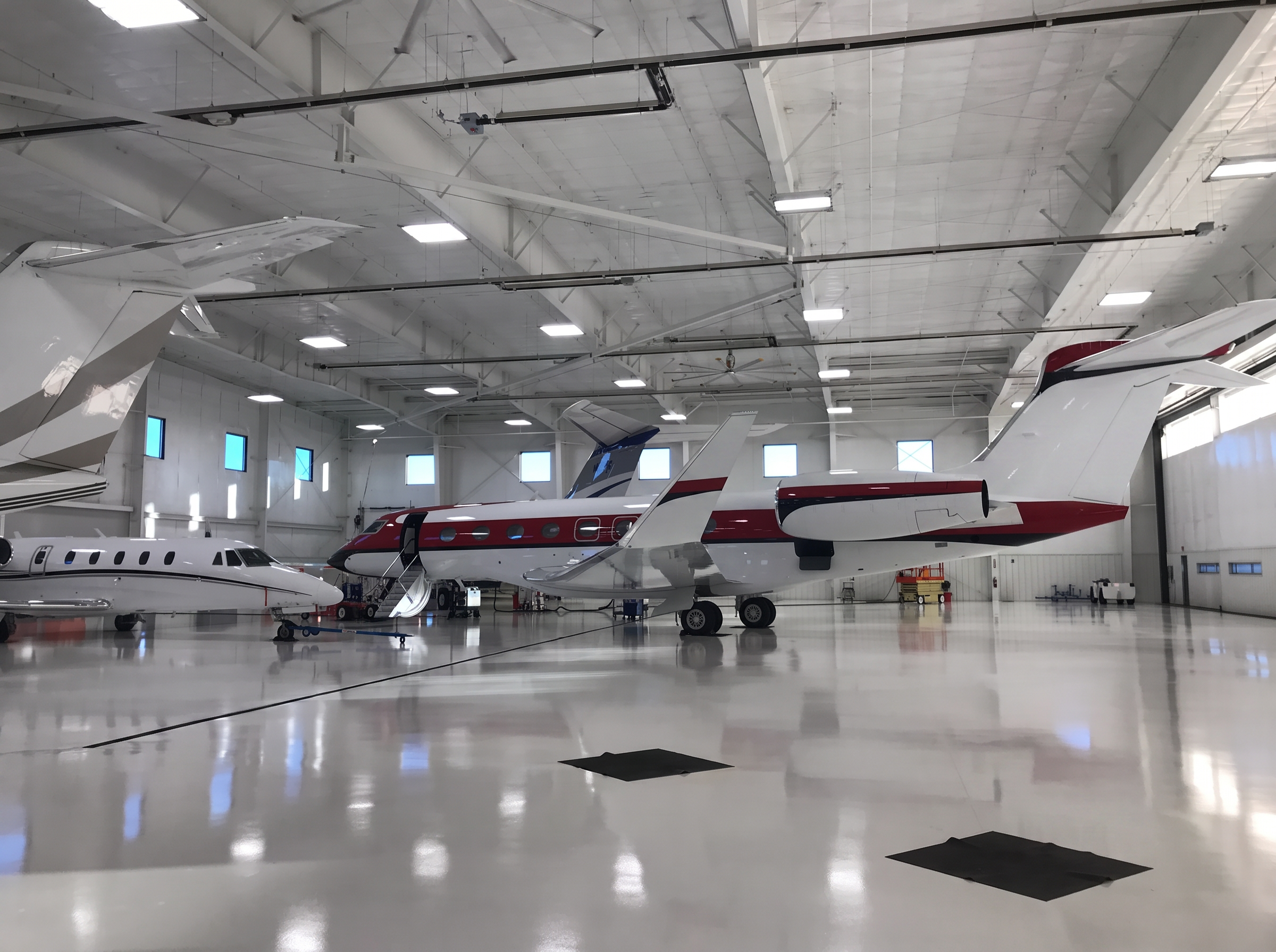 Business jets parked inside the climate-controlled Airmax hangar