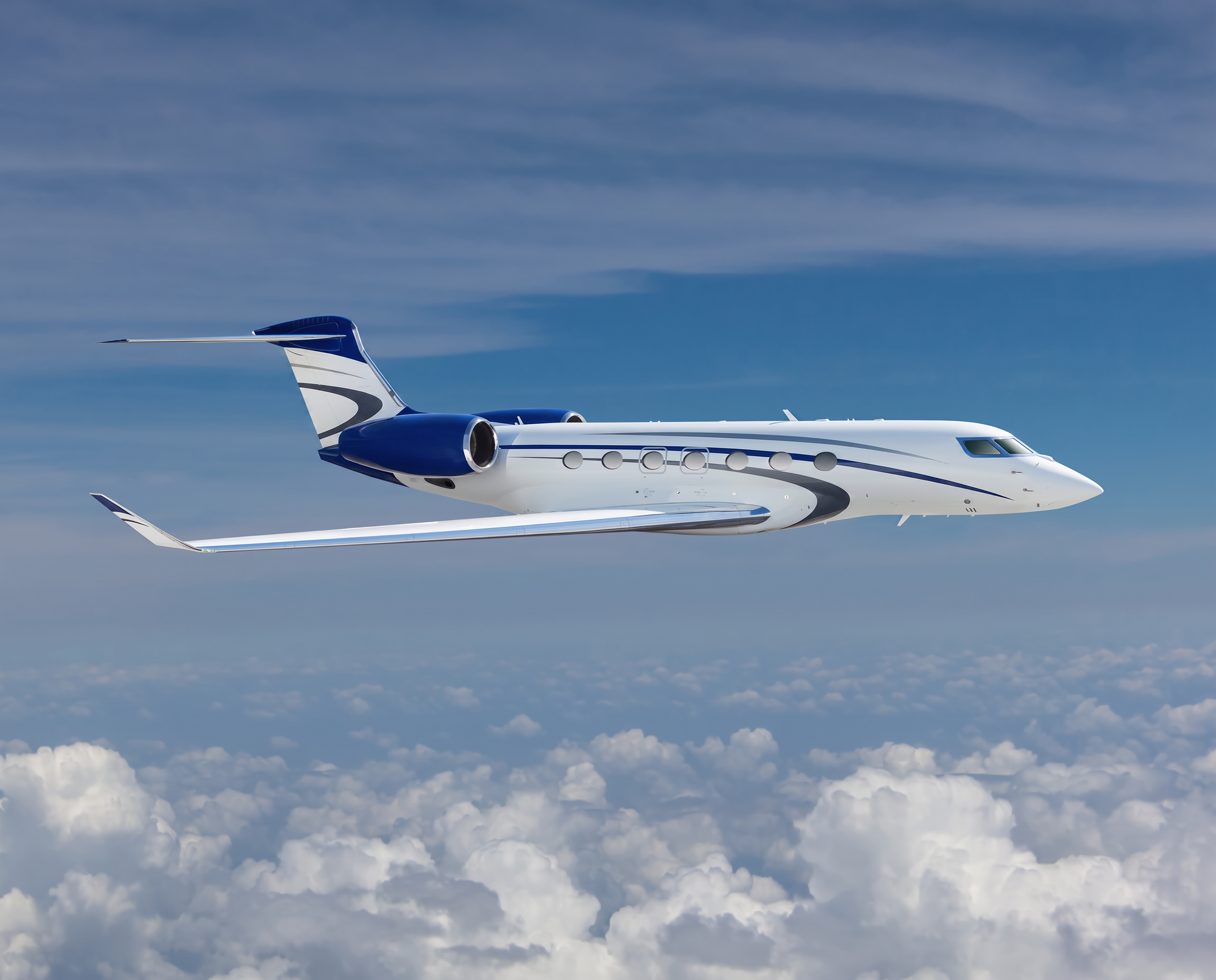 Navy and white Gulfstream business jet in flight above the clouds